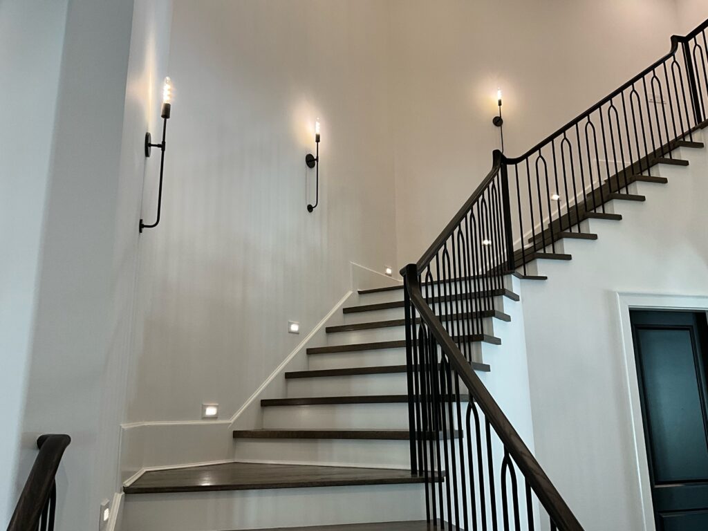 Modern industrial sconces along a staircase