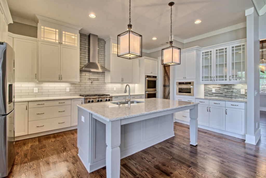 Brightly lit kitchen with pendant lights, inset LED can lights, under cabinet lighting, etc.